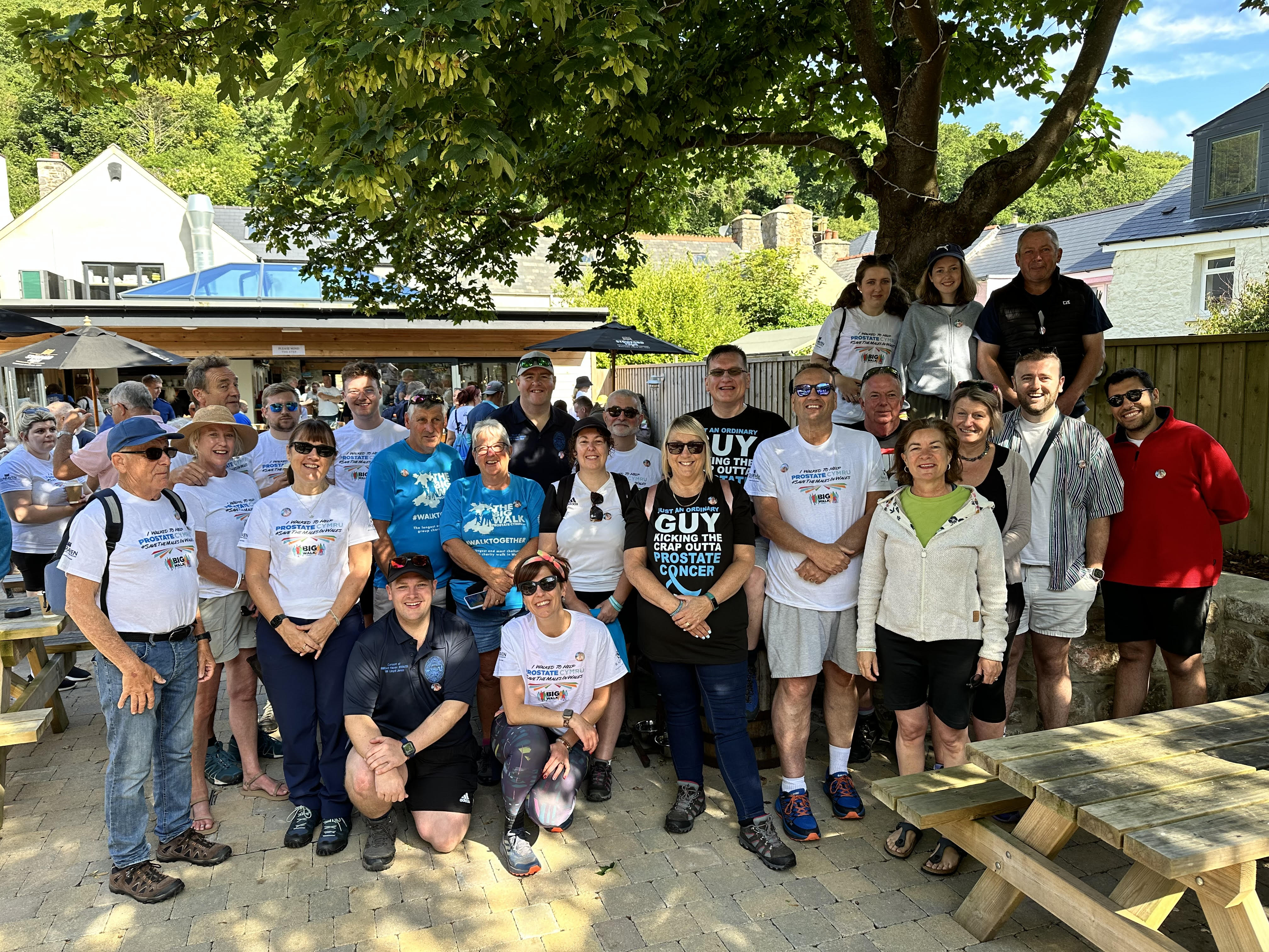 start-of-the-big-walk-last-summer-raising-money-for-prostate-cymru-guy-is-in-the-back-row-with-the-guy-t-shirt-he-is-pictured-with-friends-family-and-first-minister-eluned-morgan.jpg